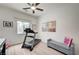 Bright bedroom with a treadmill, grey bench, ceiling fan and a window offering natural light and a view at 83 Buckthorn Ridge Ct, Las Vegas, NV 89183