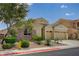 Charming single-story home featuring stone accents, a two-car garage, and a well-maintained desert landscape at 83 Buckthorn Ridge Ct, Las Vegas, NV 89183