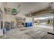 Spacious three-car garage with ample storage shelving, open door to community, and plenty of room for parking at 83 Buckthorn Ridge Ct, Las Vegas, NV 89183