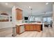 Charming kitchen with stainless steel appliances, a breakfast bar, and an open view of the living area at 83 Buckthorn Ridge Ct, Las Vegas, NV 89183