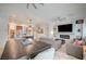 Expansive open-concept space featuring wood-look floors, modern design elements, and seamless flow to the kitchen at 83 Buckthorn Ridge Ct, Las Vegas, NV 89183