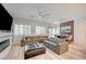 Spacious living room featuring modern furnishings, a stylish fireplace, wood-look flooring and abundant natural light at 83 Buckthorn Ridge Ct, Las Vegas, NV 89183
