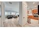 Bright, open-concept living room with hardwood floors and updated kitchen with stainless steel appliances at 83 Buckthorn Ridge Ct, Las Vegas, NV 89183