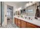 Main bathroom with double vanity, decorative floor tiles, and direct access to the main bedroom at 83 Buckthorn Ridge Ct, Las Vegas, NV 89183