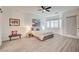 Bright main bedroom featuring wood floors, a ceiling fan, and plenty of natural light at 83 Buckthorn Ridge Ct, Las Vegas, NV 89183