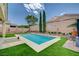 Backyard features a refreshing pool, mature landscaping, and privacy wall at 83 Buckthorn Ridge Ct, Las Vegas, NV 89183
