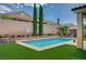 Inviting backyard pool with lush green turf, complemented by verdant landscaping for a serene outdoor oasis at 83 Buckthorn Ridge Ct, Las Vegas, NV 89183