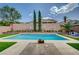Inviting backyard pool with lush green turf, complemented by verdant landscaping for a serene outdoor oasis at 83 Buckthorn Ridge Ct, Las Vegas, NV 89183