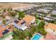 Expansive aerial view of the home with a pool, patio, solar panels, and community landscaping at 8484 Montana Stream Ave, Las Vegas, NV 89113
