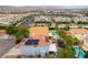 Aerial view of the home with a pool and spa, patio, solar panels, and mature landscaping at 8484 Montana Stream Ave, Las Vegas, NV 89113