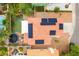 Aerial view of a backyard with a pool, trampoline, green lawn and solar panels on the red tile roof at 8484 Montana Stream Ave, Las Vegas, NV 89113