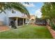 Sprawling backyard featuring a covered patio, manicured lawn, trampoline and mature landscaping at 8484 Montana Stream Ave, Las Vegas, NV 89113