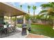 Charming backyard featuring a covered patio, outdoor furniture, and manicured lawn with space to entertain at 8484 Montana Stream Ave, Las Vegas, NV 89113