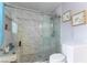 Bright renovated bathroom featuring glass shower doors, tiled walls, and rainfall shower head at 8484 Montana Stream Ave, Las Vegas, NV 89113