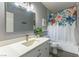 Bathroom features a vanity, mirror and shower with floral curtain at 8484 Montana Stream Ave, Las Vegas, NV 89113