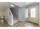 Bright entryway with a staircase, wood-look floors, a decorative rug, and a front door with glass panes at 8484 Montana Stream Ave, Las Vegas, NV 89113