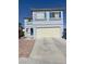 Two-story home with blue shutters and a two-car garage on a sunny day at 8484 Montana Stream Ave, Las Vegas, NV 89113