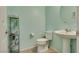 Powder room features a modern toilet, pedestal sink, and a mirrored medicine cabinet at 889 Harbor Ave, Henderson, NV 89002