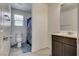 The bathroom features marble tile floors, a toilet, a sink with vanity, and a shower with curtain at 889 Harbor Ave, Henderson, NV 89002