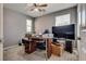 Cozy bedroom with carpeted floor, ceiling fan, natural light and an office desk at 889 Harbor Ave, Henderson, NV 89002