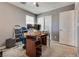 The carpeted bedroom features a ceiling fan, natural light, a closet, and a sliding door at 889 Harbor Ave, Henderson, NV 89002