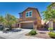 Charming two-story home boasting mature trees, a two-car garage, and manicured landscaping at 889 Harbor Ave, Henderson, NV 89002