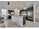 Open-concept kitchen featuring a large island, stainless steel appliances, and barstool seating at 889 Harbor Ave, Henderson, NV 89002