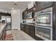 Modern kitchen features dark wood cabinets, stainless steel appliances, granite countertops, and tile flooring at 889 Harbor Ave, Henderson, NV 89002