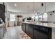 Open-concept kitchen featuring a central island, granite countertops, and a view of the living area at 889 Harbor Ave, Henderson, NV 89002