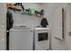 Laundry room featuring a washer, dryer, shelving and a door leading to the other spaces in the home at 889 Harbor Ave, Henderson, NV 89002