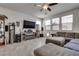 Spacious living room with tile flooring, a large sectional sofa, and a modern media center at 889 Harbor Ave, Henderson, NV 89002