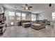 Open-concept living room with tile flooring, a ceiling fan, and lots of natural light at 889 Harbor Ave, Henderson, NV 89002
