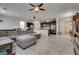 Open-concept living space flows into a kitchen with a large sectional, tile floor, and stairs at 889 Harbor Ave, Henderson, NV 89002