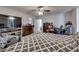 Spacious main bedroom featuring a ceiling fan, TV, a comfortable chair, and carpeted floors at 889 Harbor Ave, Henderson, NV 89002