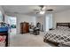 This main bedroom features carpet flooring, neutral walls, a ceiling fan, and an entrance to a different room at 889 Harbor Ave, Henderson, NV 89002