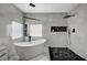 Elegant bathroom featuring a standalone tub, a walk-in shower, and marble-like tiling at 8953 Paige Rene Ct, Las Vegas, NV 89117