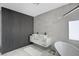 Modern bathroom with a double sink vanity, standalone tub, and a stylish accent wall at 8953 Paige Rene Ct, Las Vegas, NV 89117