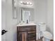 Cozy bathroom with a rustic vanity, updated fixtures, and decorative mirror at 8953 Paige Rene Ct, Las Vegas, NV 89117