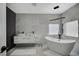 Modern bathroom with double sinks, standalone tub, marble-like tiling, and sleek fixtures at 8953 Paige Rene Ct, Las Vegas, NV 89117