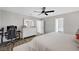 Bedroom with light grey walls, wood floors, a gaming setup, and an ensuite bathroom at 8953 Paige Rene Ct, Las Vegas, NV 89117