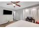 Bedroom with fan, work desk and plush bed, offering a versatile living space at 8953 Paige Rene Ct, Las Vegas, NV 89117