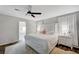 Bedroom featuring white walls and furniture, wood flooring, and a ceiling fan at 8953 Paige Rene Ct, Las Vegas, NV 89117
