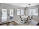 Dining room features a white table and chairs, modern lighting, and patio access at 8953 Paige Rene Ct, Las Vegas, NV 89117