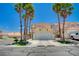 Inviting two-story home with a spacious driveway, lush landscaping, and mature palm trees at 8953 Paige Rene Ct, Las Vegas, NV 89117