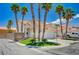 Charming two-story home featuring a well-manicured lawn and tall palm trees against a clear blue sky at 8953 Paige Rene Ct, Las Vegas, NV 89117