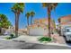 Well-maintained home with a two-car garage, neatly landscaped yard, and mature palm trees at 8953 Paige Rene Ct, Las Vegas, NV 89117