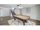 Large game room with a pool table, modern lighting, and a staircase leading to the upper level at 8953 Paige Rene Ct, Las Vegas, NV 89117