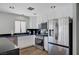 Modern kitchen features stainless steel appliances, black countertops, and white cabinetry at 8953 Paige Rene Ct, Las Vegas, NV 89117