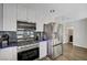 Modern kitchen features stainless steel appliances, gas range and white cabinetry at 8953 Paige Rene Ct, Las Vegas, NV 89117