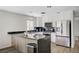 Modern kitchen features stainless steel appliances, breakfast bar, and white cabinetry at 8953 Paige Rene Ct, Las Vegas, NV 89117